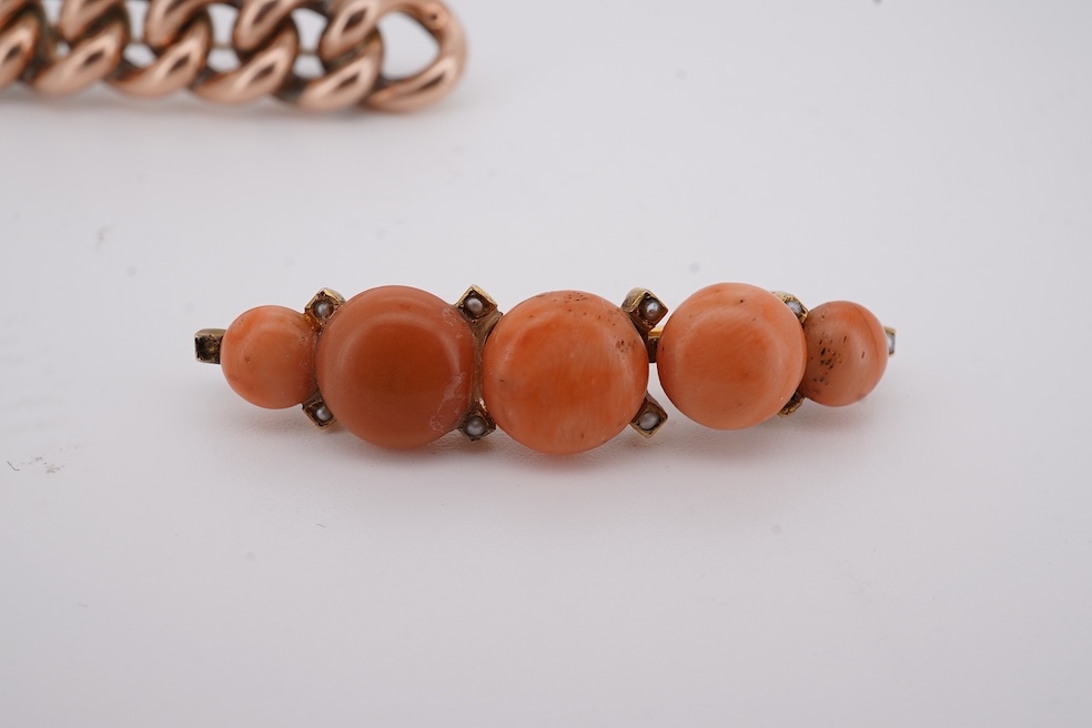 An early 20th century yellow metal and graduated five stone coral bead brooch, with seed pearl spacers, 45mm, together with a yellow metal curb link brooch and a yellow metal (stamped 9c) safety pin. Condition - fair